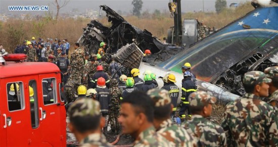 Rescuers work at the plane crash site in Kathmandu, Nepal, on March 12, 2018. At least 49 people were killed and 17 injured after a passenger plane of the US-Bangla Airlines crashed at Nepal's Tribhuvan International Airport (TIA) on Monday afternoon, authorities confirmed. (Xinhua/Sunil Sharma)