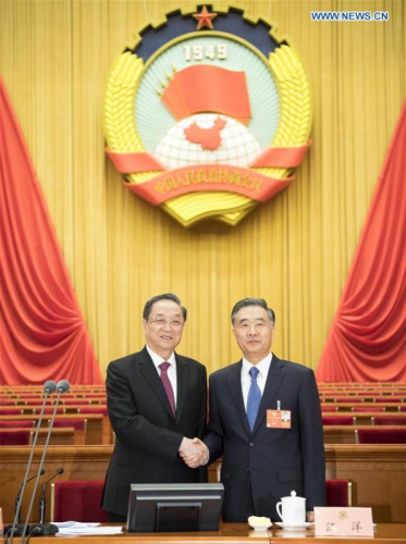 Yu Zhengsheng, chairman of the 12th National Committee of the Chinese People's Political Consultative Conference (CPPCC), shakes hands with Wang Yang, who presides over a presidium meeting of the first session of the 13th CPPCC National Committee, during a preparatory meeting for the first session of the 13th CPPCC National Committee in Beijing, capital of China, March 2, 2018. (Xinhua/Li Xueren)