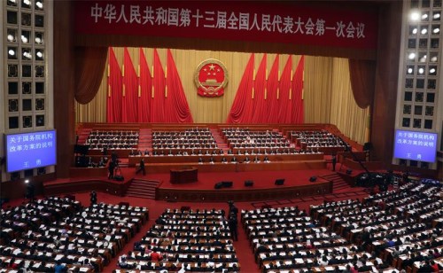 The fourth plenary meeting of the first session of the 13th National Peoples Congress is held at the Great Hall of the People in Beijing on Tuesday. State Councilor Wang Yong delivered an institutional restructuring plan of the State Council. Also at the meeting, Li Jianguo, vice-chairman of the Standing Committee of the 12th National Peoples Congress, spoke about the new draft law on national supervision. (Photo/China Daily)