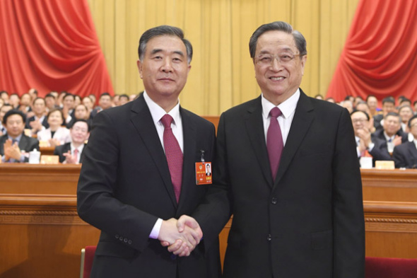Wang Yang (left), elected chairman of the 13th National Committee of the Chinese People's Political Consultative Conference, shakes hands with Yu Zhengsheng, chairman of the 12th CPPCC National Committee, on Wednesday. (Photo/Xinhua)