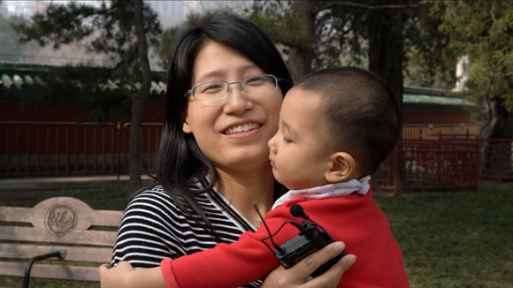 A Beijing resident and her child. (Photo/CGTN )