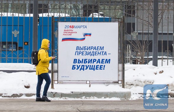 A local walks past a poster about the Russian presidential election in Moscow, capital of Russia, on March 16, 2018. (Xinhua/Bai Xueqi)