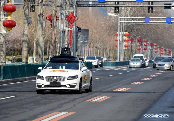 A self-driving vehicle for public road testing runs on a road in Beijing, capital of China, March 22, 2018. Beijing released its first temporary license plates for Baidu's self-driving vehicles for public road testing on Thursday. The capital city has opened 33 roads with a total length of 105 kilometers for autonomous car testing outside the Fifth Ring Road and away from densely-populated areas on the outskirts. (Xinhua/Luo Xiaoguang)
