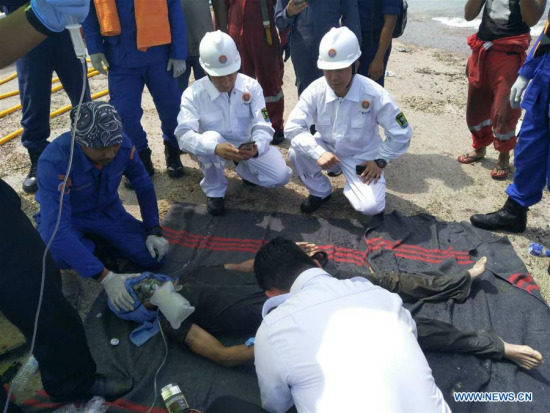 A Chinese crew member receives medical treatment after he was rescued from a capsized sand dredger in Muar of southern Malaysian state of Johor, March 23, 2018. Two Chinese crew were rescued from a sand dredger capsized in the waters near Malaysia, according to the Chinese embassy in Malaysia on Friday. (Xinhua)