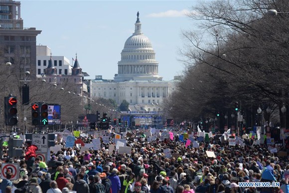 People take part in the March for Our Lives rally in Washington D.C., the United States, on March 24, 2018. Hundreds of thousands of people gathered at Pennsylvania Avenue in Washington D.C. on Saturday for the March for Our Lives gun control rally, demanding the end of gun violence and mass school shootings. (Xinhua/Yang Chenglin)