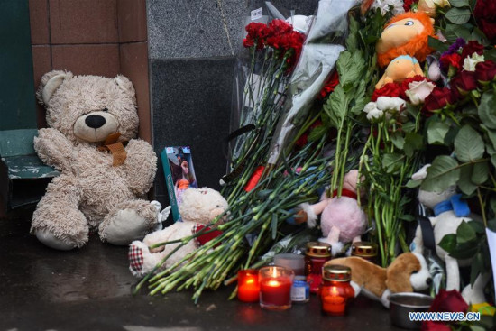 Flowers and dolls are placed outside the doors of the Kemerovo region representative office in Moscow to mourn the victims of the fire at a shopping mall in Kemerovo, in Moscow, Russia, on March 26, 2018. At least 64 people were killed in a fire in Zimnyaya Vishnya shopping mall in south central Russia's Kemerovo city on Sunday. (Xinhua/Evgeny Sinitsyn)