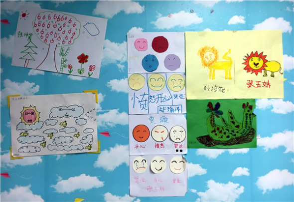 Drawings by child patients are displayed on the classroom wall. (YUAN QUAN/XINHUA)