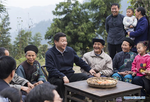 Xi Jinping talks with local villagers and cadres at Shibadong Village in Paibi Township of Huayuan County in the Tujia-Miao Autonomous Prefecture of Xiangxi, Central China's Hunan Province, Nov 3, 2013. (Photo/Xinhua)