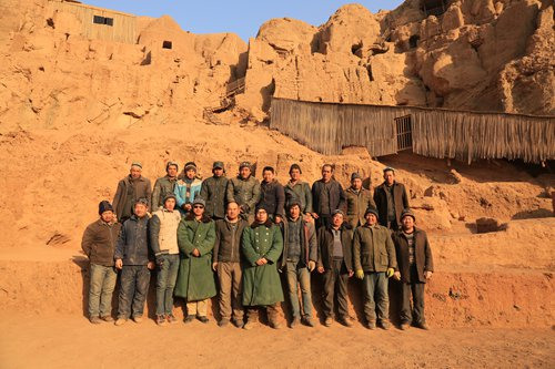 Archeologists at the Tuyugou Grottoes site pose for a picture. (Photo/Courtesy of Xia Lidong)