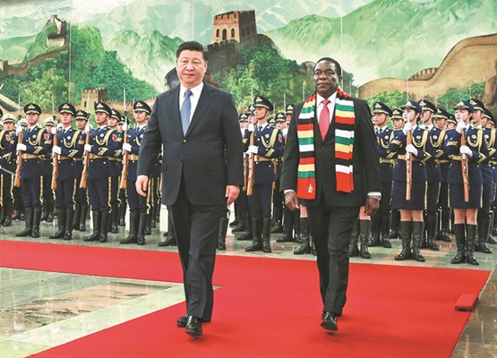 President Xi Jinping escorts Zimbabwe President Emmerson Mnangagwa during a visit on Tuesday at the Great Hall of the People in Beijing. Both men observed several documents being signed during Mnangagwa's visit. (Photo/Xinhua)