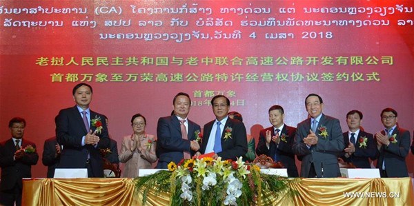 Representatives of the Laos-China Joint Expressway Development, China Yunnan Construction and Investment Holding Group (YCIH) and the Lao Planning and Investment Ministry attend a signing ceremony of a concession agreement for Laos' first expressway in Vientiane, Laos, April 4, 2018. (Xinhua/Liu Ailun)