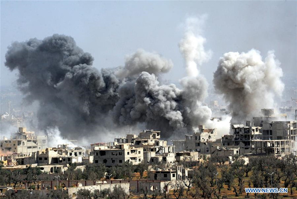 Smoke rises after the Syrian army's shelling targeted the Douma district in Eastern Ghouta countryside of Damascus, Syria, on April 7, 2018. The Syrian army on Saturday stormed the frontlines of the Islam Army in the Douma district of the capital Damascus' Eastern Ghouta countryside, state news agency SANA reported. (Xinhua/Ammar Safarjalani)