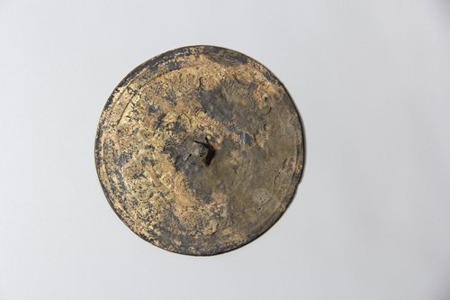 A bronze mirror unearthed at the M154 site. (Photo/Courtesy of Wang Tianyou)
