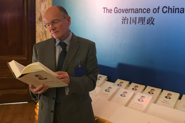 A foreigner reads the second volume of Xi Jinping: The Governance of China. (Photo provided to China Daily)