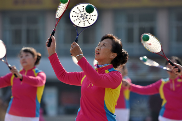 Retirees and homemakers practise taichi at a playground in Chaohu, Anhui province. (Photo by Li Yuanbo/For China Daily)