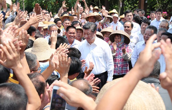 Chinese President Xi Jinping, also general secretary of the Communist Party of China Central Committee and chairman of the Central Military Commission, shakes hands with villagers in Shicha Village of Xiuying District in Haikou, south China's Hainan Province, April 13, 2018. Xi made an inspection tour in Hainan from Wednesday to Friday. (Xinhua/Xie Huanchi)