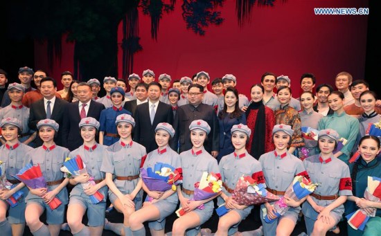 Kim Jong Un, top leader of the Democratic People's Republic of Korea, and his wife Ri Sol Ju pose for a group photo with dancers after watching the ballet The Red Detachment of Women performed by a visiting Chinese art troupe in Pyongyang, the Democratic People's Republic of Korea, April 16, 2018. (Xinhua/Yao Dawei)