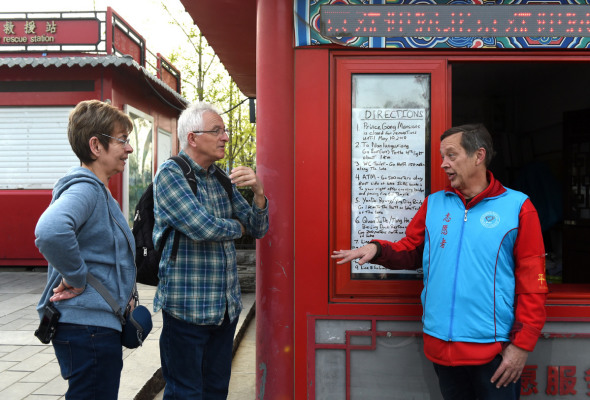 Gao talks with foreign tourists. (Photo/Xinhua)