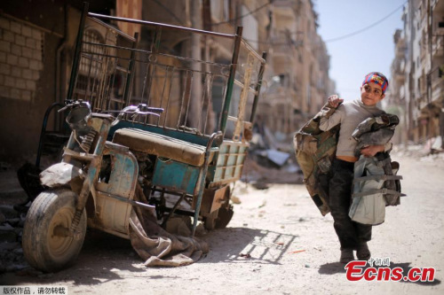 A boy walks along a damaged street at the city of Douma in Damascus, Syria, April 16, 2018. (Photo/Agencies)