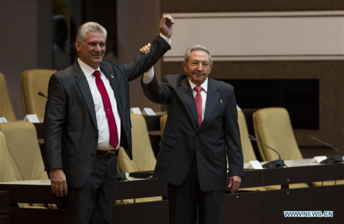 Raul Castro (R) raises the hand of Miguel Diaz-Canel during a session of the National Assembly of People's Power in Havana, capital of Cuba, April 19, 2018. Miguel Diaz-Canel was elected on Thursday as Cuba's new president, as the successor of Raul Castro, who concluded two consecutive five-year terms in office. (Xinhua/Irene Perez/CUBADEBATE)