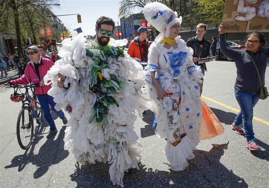 Participants dress with costumes that made with plastic bags during the Earth Day Parade in Vancouver, Canada, on April 21, 2018. Hundreds of people took part in the acitivity to show support for environmental protection.