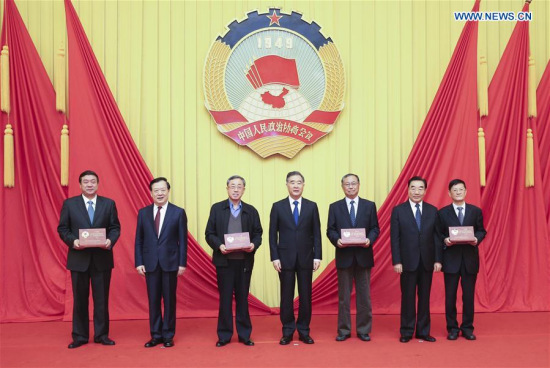 Wang Yang (C), chairman of the National Committee of the Chinese People's Political Consultative Conference (CPPCC), presents memorial plates to some Standing Committee members of the 12th CPPCC National Committee, who retired in March after the 13th CPPCC National Committee was formed, in Beijing, capital of China, April 24, 2018. (Xinhua/Yao Dawei)