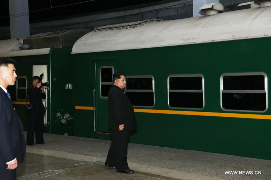 Kim Jong Un (R), top leader of the Democratic People's Republic of Korea (DPRK), watches the train leaving the station in Pyongyang, the DPRK, on April 25, 2018. (Xinhua/Cheng Dayu)