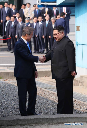 South Korean President Moon Jae-in (L) shakes hands with top leader of the Democratic People's Republic of Korea (DPRK) Kim Jong Un in the border village of Panmunjom on April 27, 2018. Moon Jae-in arrived Friday morning in the border village of Panmunjom for his first summit with Kim Jong Un. (Xinhua/Inter-Korean Summit Press Corps)