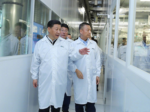 President Xi Jinping visits an integrated circuit production line at a technology company in Wuhan on Thursday. The largest city in Central China, Wuhan is a focal point in the economic belt being developed under the president's guidance. (Photo/Xinhua)