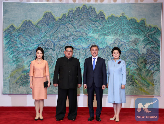 South Korean President Moon Jae-in (2nd R) and his wife Kim Jung-sook (1st R) pose for photos with Kim Jong Un (2nd L), top leader of the Democratic People's Republic of Korea (DPRK) and his wife Ri Sol Ju at Peace House on the South Korean side of Panmunjom, on April 27, 2018. (Photo/Xinhua)