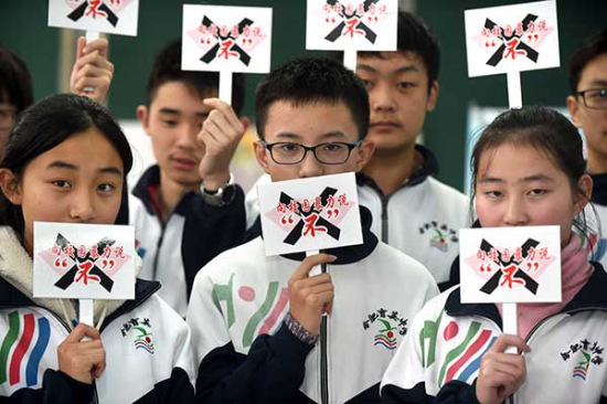 Students hold placards that read 