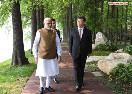 Chinese President Xi Jinping (R) walks with Indian Prime Minister Narendra Modi in Wuhan, capital of central China's Hubei Province, April 28, 2018. Xi held an informal meeting with Indian Prime Minister Narendra Modi Friday and Saturday in Wuhan. (Xinhua/Yan Yan)
