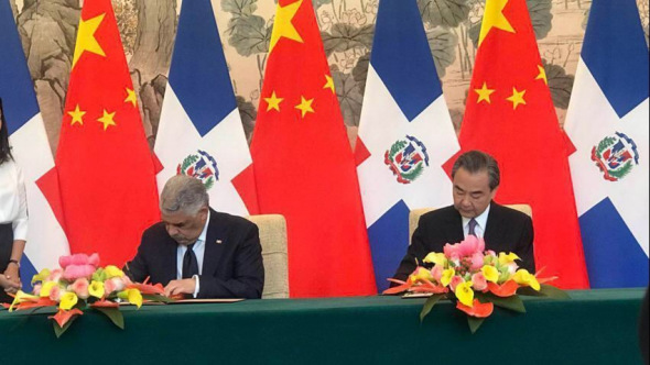 Chinese Foreign Minister Wang Yi and his Dominican counterpart Miguel Vargas Maldonado  sign a joint communique in Beijing Tuesday on the establishment of diplomatic relations. (Photo/CGTN)