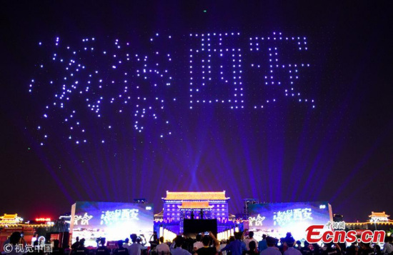 Drones make a formation in the air over the illuminated Yongning Gate in Xi'an City, capital of Northwest China's Shaanxi Province, May 1, 2018. A total of 1,374 drones were used to form various patterns, such as the old city wall and scenes from the Silk Road, in the opening ceremony of a cultural festival named after Xi'an's well-preserved old city wall built during the Ming Dynasty (1368-1644). (Photo/VCG)