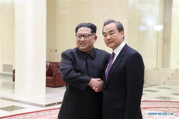 Top leader of the Democratic People's Republic of Korea (DPRK) Kim Jong Un (L) shakes hands with Chinese State Councilor and Foreign Minister Wang Yi in Pyongyang, the DPRK, May 3, 2018. (Xinhua)