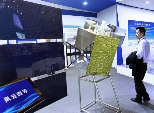 A model of the Fengyun IV meteorological satellite is displayed during an exhibition in Shanghai. (Ding Ting/Xinhua)