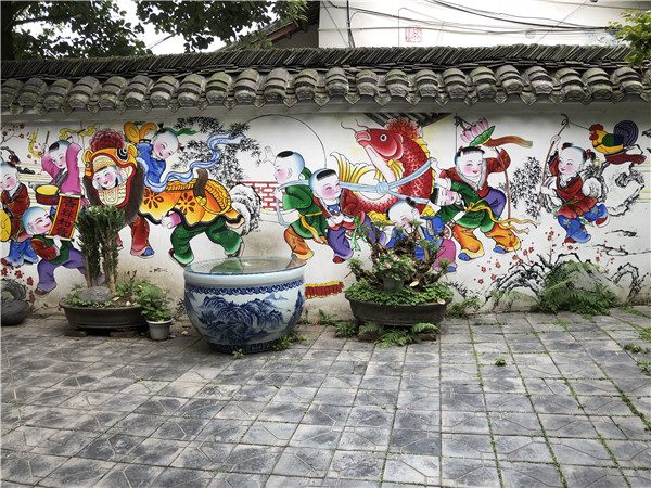 Colorful and vivid traditional Chinese New Year paintings are seen on the wall of a residence at Nianhua village in Xiaode town, Mianzhu city, Southwest Chinas Sichuan province, May 5, 2018. (Photo by Yao Yao/chinadaily.com.cn)