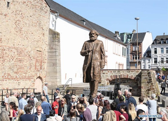 Visitors gather in front of the Karl Marx statue in Trier, Germany, on May 5, 2018. A China-donated statue of German philosopher Karl Marx was unveiled on Saturday in his birth town on the 200th anniversary of his birth. (Xinhua/Shan Yuqi)