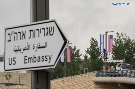 Jerusalem municipal workers install U.S. and Israeli flags near the U.S. Consulate General in Jerusalem, on May 7, 2018. U.S. President Donald Trump on Monday announced the designation of a presidential delegation to Israel to attend the opening of the U.S. embassy. According to a White House statement, the opening ceremony will be on May 14. (Xinhua/JINI)