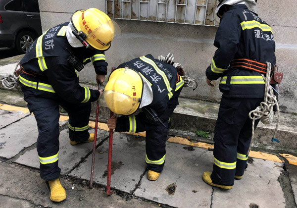 Firefighters dig into a tunnel covered by concrete slabs in Zhanjiang, Guangdong province, to rescue a cat. Photo/CHINA DAILY BY XIASHAN FIRE BRIGADE ONLINE