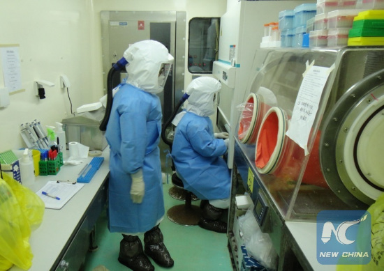 File photo shows members of Chinese mobile laboratory team work at a laboratory in Freetown, capital of Sierra Leone, Jan. 22, 2015, by which time the team had tested 3,995 Ebola-related blood samples including 1,407 tested positive. (Xinhua/Xin Wenwen)