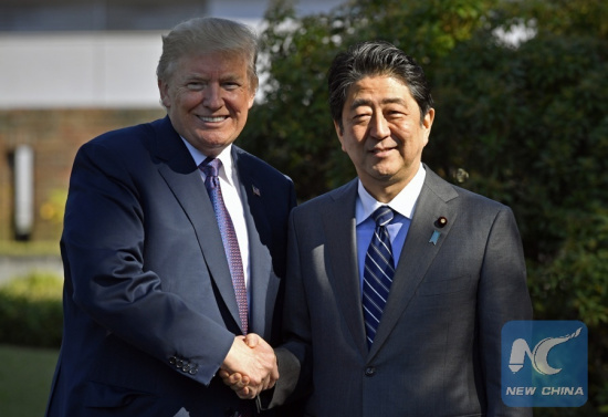 File Photo: U.S. President Donald Trump (L) shakes hands with Japanese Prime Minister Shinzo Abe upon his arrival at the Kasumigaseki Country Club in Kawagoe, near Tokyo, Japan, Nov. 5, 2017. (Xinhua)