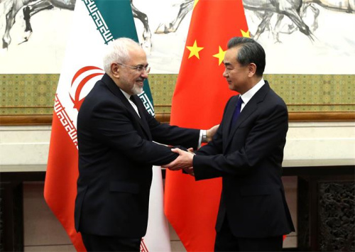 State Councilor and Foreign Minister Wang Yi meets Iranian Foreign Minister Mohammad Javad Zarif on Sunday. Wang said China will uphold the Iran nuclear deal in an objective, just and responsible manner. (FENG YONGBIN/CHINA DAILY)