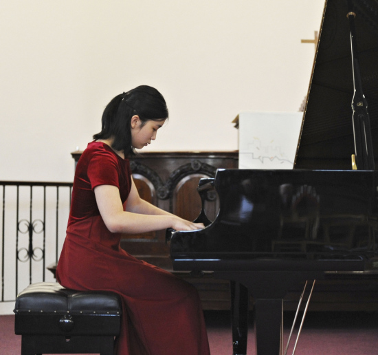 Lauren Zhang plays the piano. (Photo provided to China Daily)