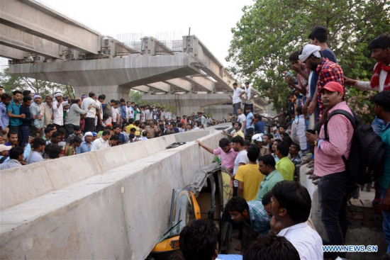 People gather at the site where an under-construction flyover collapsed in Varanasi district, Uttar Pradesh, India, on May 15, 2018. (Xinhua)