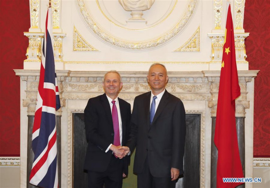 Cai Qi (R), a member of the Political Bureau of the Central Committee of the Communist Party of China (CPC) and secretary of the CPC Beijing Municipal Committee, meets with Britain's Cabinet Office Minister David Lidington, in London, Britain, May 14, 2018. Cai Qi on Tuesday wrapped up his five-day trip to Britain. (Xinhua/Han Yan)