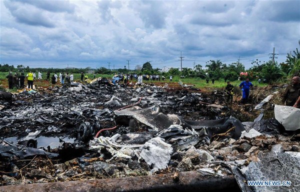 Rescuers work at the site where an airplane of Cuban airline 