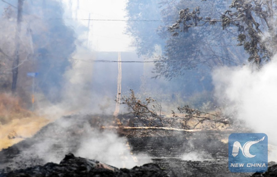 Volcanic debris are seen on a road in Leilani Estate, Hawaii, the United States, May 9, 2018. According to reports of the Hawaii State government, eruptions of the KilaueaVolcano had forced the evacuation of thousands of people. (Xinhua/Tao Xiyi)