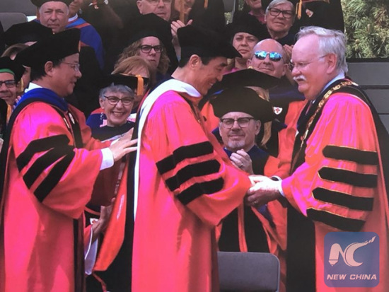 Chinese filmmaker Zhang Yimou (C) received an honorary Doctor of Humanize Letters from the Boston University at its 145th Commencement on May 20, 2018. (Xinhua Photo/Dong Ding)