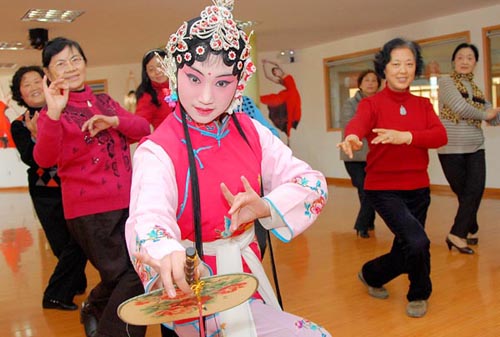 A young Kunqu actress is performing in front of the public